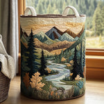 Quilted storage basket with a forest stream and mountain landscape design
